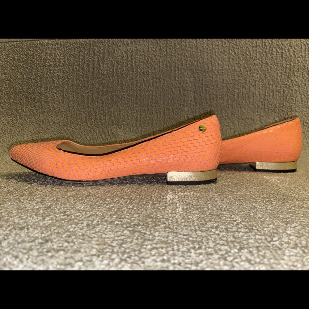 Calvin Klein flats in peach with gold.